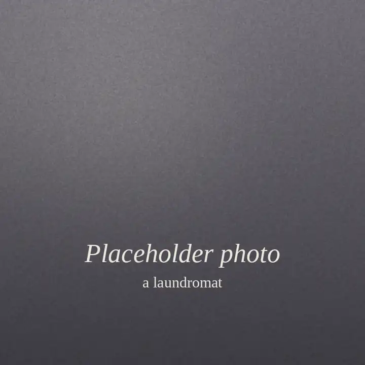 Placeholder: a plain grey-violet square standing in for a photo of a laundromat.